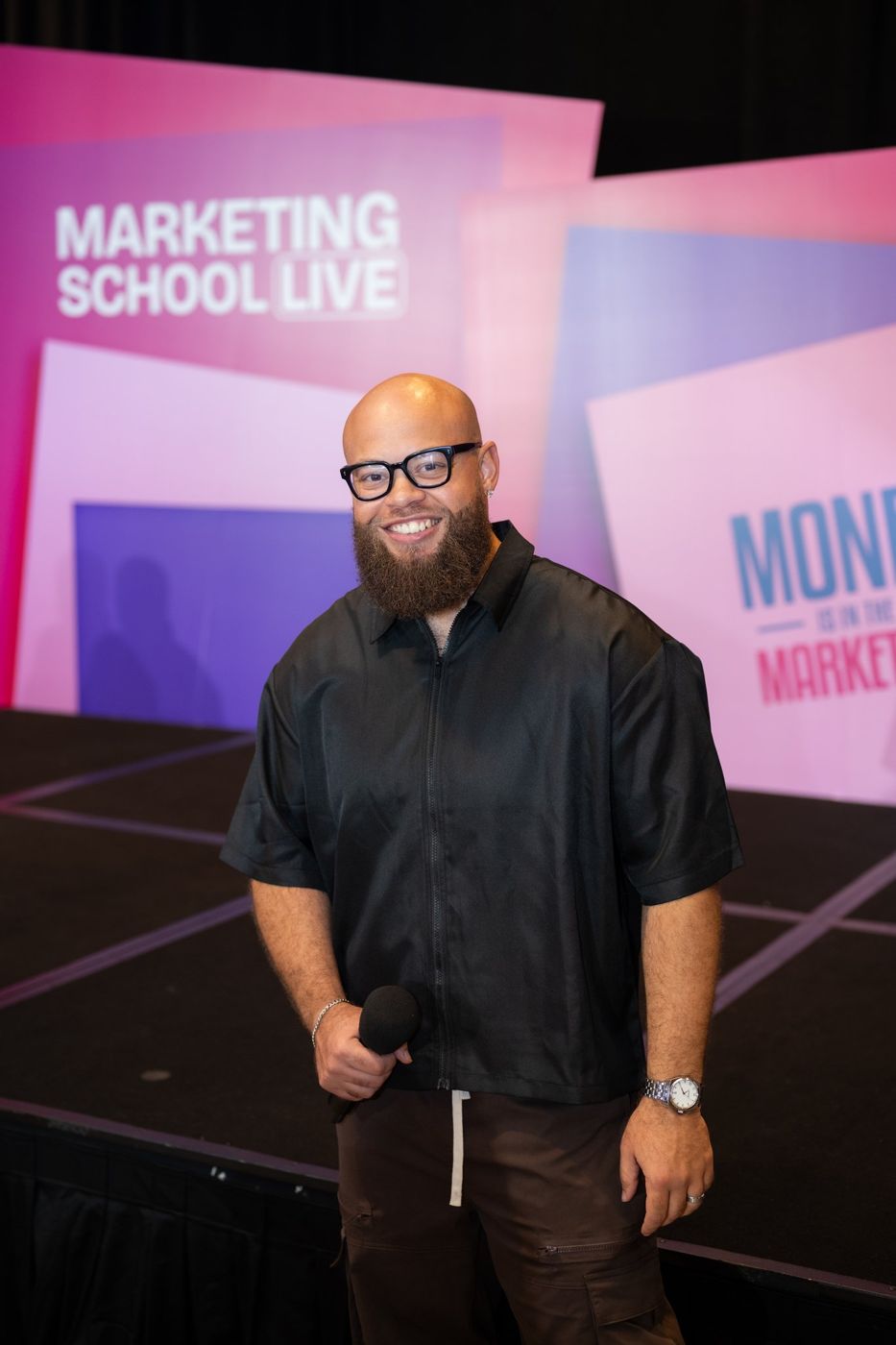 A speaker with a mic in front of the MSL stage