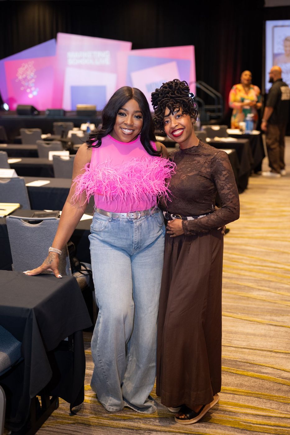 Two attendees posing in the main room