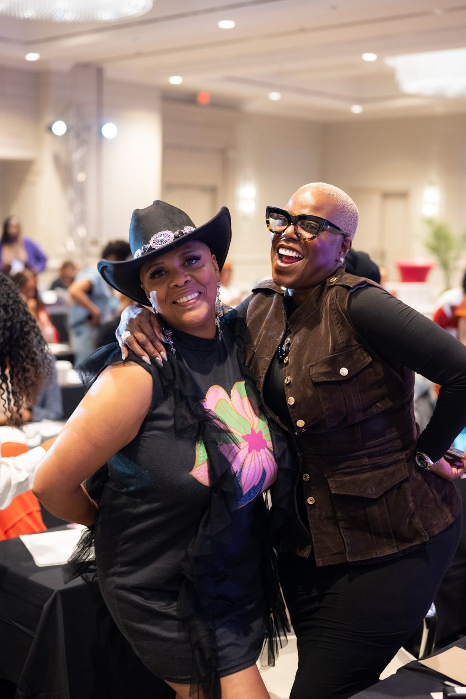 Two attendees laughing together